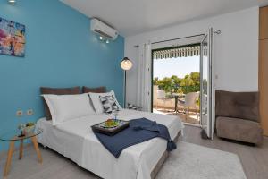 a blue bedroom with a bed and a balcony at Apartment Chiara in Tučepi