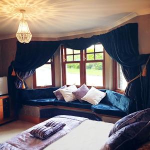 a bedroom with two beds and a window at Bogenraith House in Banchory