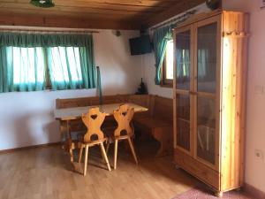 a dining room with a wooden table and chairs at Vineyard Cottage Janko & Metka in Otočec