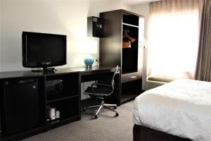 a hotel room with a bed and a desk with a television at Sleep Inn Chattanooga Hamilton Place in Chattanooga