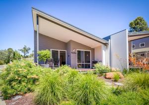 a modern house with a garden in front of it at Villa 28 Cape Villas in Dunsborough