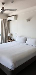 a large white bed in a room with a window at Crown Towers Resort Private Apartments in Gold Coast