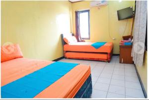 Ein Bett oder Betten in einem Zimmer der Unterkunft Budi House & Food Station