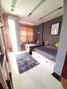 a bedroom with two beds and a rug at Homestay StarFish Quy Nhơn in Quy Nhon
