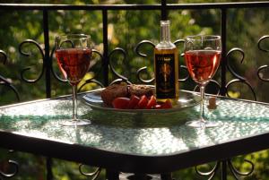a table with two glasses of wine and a plate of food at Sevastie's Home - downstairs in Samothraki