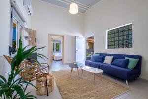 a living room with a blue couch and a table at Rikia Seaside House in Rikia