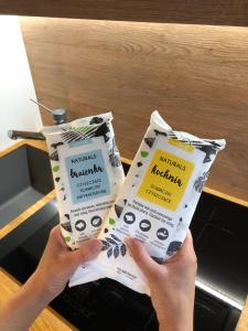 a person holding two packets of raisinolis breakfast food at Apartament RadMila2 in Radom