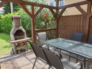 a patio with a table and a pizza oven at Holiday Home Domeček in Lipova Lazne