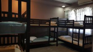 a group of bunk beds in a room at Ranau Backpackers Hostel in Ranau