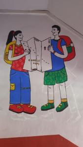 a painting of three people holding a map at Ranau Backpackers Hostel in Ranau