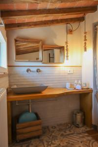 łazienka z umywalką i lustrem w obiekcie B&B La Taccola w mieście Castelnuovo di Val di Cecina