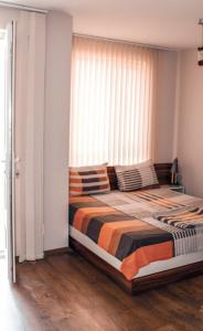 a bedroom with a large bed with a window at Ecostar 10.1.B in Rogachevo