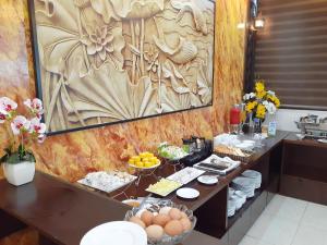 ハノイにあるT&M Luxury Hotel Hanoiの卵料理と食べ物をテーブルに並べたビュッフェ