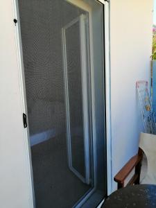 a glass door of a shower in a room at Jason Rooms & Studios in Keratokampos