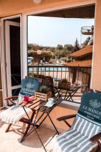 two chairs and a table on a patio with a view at La Mer Apartment in Rogachevo