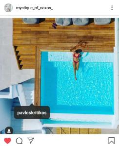 a woman is diving into a swimming pool at Majestique of Naxos in Naxos Chora