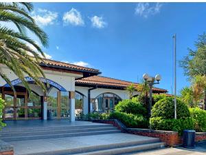 a building with stairs and a palm tree at Bonita HouseBoat Apartment Portorose in Portorož