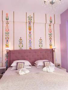 - une chambre avec un grand lit aux murs violets dans l'établissement Rozmari and Spa, à Agia Galini