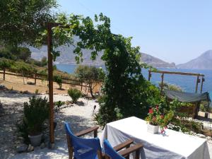 a table and chairs with a view of the ocean at Sylvia's houses in Kalymnos
