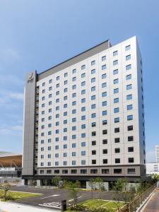 a large white building with a lot of windows at Far East Village Hotel Tokyo Ariake in Tokyo