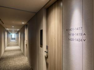 a corridor of a hallway with writing on the wall at Far East Village Hotel Tokyo Ariake in Tokyo