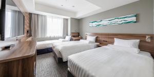 a hotel room with two beds and a sink at Far East Village Hotel Tokyo Ariake in Tokyo