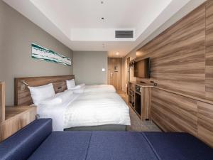 a hotel room with a bed and a tv at Far East Village Hotel Tokyo Ariake in Tokyo