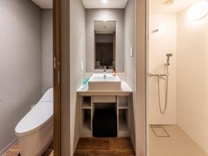 a bathroom with a sink and a tub and a toilet at Far East Village Hotel Tokyo Ariake in Tokyo