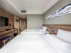 a hotel room with two beds and a tv at Far East Village Hotel Tokyo Ariake in Tokyo