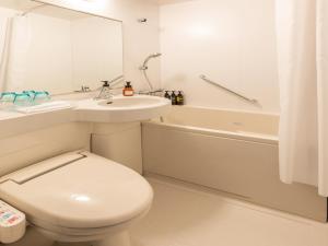 a bathroom with a toilet and a sink and a tub at Far East Village Hotel Tokyo Ariake in Tokyo