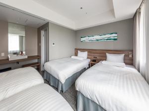 a hotel room with two beds and a sink at Far East Village Hotel Tokyo Ariake in Tokyo