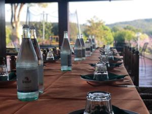 a long wooden table with bottles of water on it at Agriturismo Santa Lorica in Sassetta