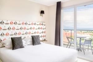 a bedroom with a white bed and a balcony at Best Western Plus Antibes Riviera in Antibes
