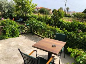 a wooden table and chairs on a patio at Cunda La Vie in Balıkesir