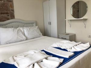 a bedroom with a bed with towels on it at Cunda La Vie in Balıkesir