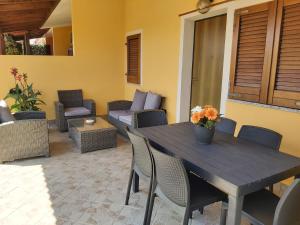 a patio with a table and chairs and a couch at Alice's House in Pula