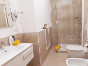 a bathroom with a shower and a toilet and a sink at Trieste Center Rooms & Apartments - Fiori di Trieste in Trieste +24 photos