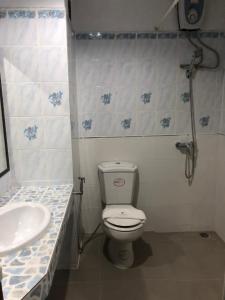 a bathroom with a toilet and a sink at Blue Garden Resort Pattaya in Jomtien Beach