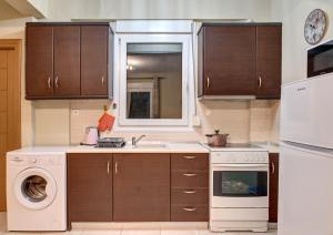 a kitchen with a sink and a dishwasher at Achilleas Apartments in Kalives Poligirou