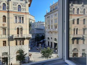 a view of a city street from a window at Trieste Center Rooms & Apartments - Fiori di Trieste in Trieste