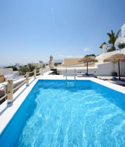 a swimming pool on the roof of a villa at White Dream Suites in Fira
