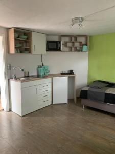 a kitchen with a sink and a bed in a room at Ferienwohnung Hoppe in Bad Münder am Deister