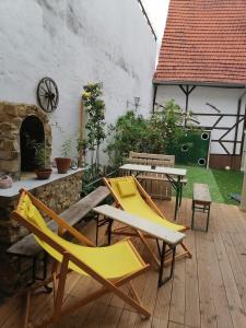 a patio with chairs and a table and a fireplace at Gasthaus Zur Rose in Malsch
