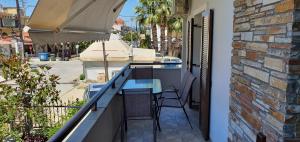 a balcony with a table and chairs on a building at Anna Rooms in Ierissos