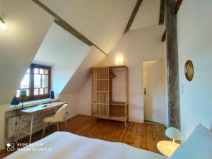 an attic room with a desk and a bed at VILLA SERANDITE maison de famille in Annecy
