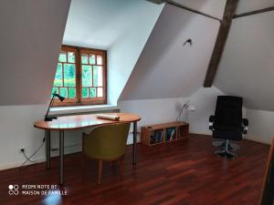 an attic room with a desk and a chair at VILLA SERANDITE maison de famille in Annecy