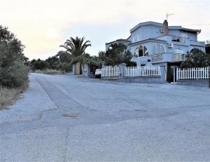 an empty road in front of a house at The Flintstones House in Limenaria +24 photos