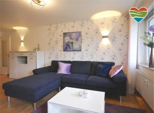 a living room with a couch and a table at Ferienwohnung M am Kurpark**** inkl. MeineCard+ in Willingen