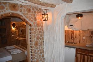 una camera con letto e parete in pietra di The Flintstones House a Limenaria
