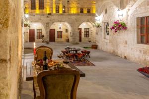 a room with a table and chairs in a building at Zeydem Suites in Urgup